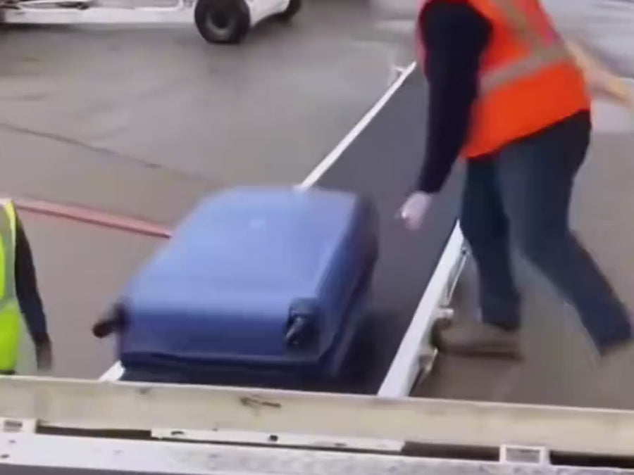 Checked suitcases thrown by baggage handlers and waiting at baggage claim